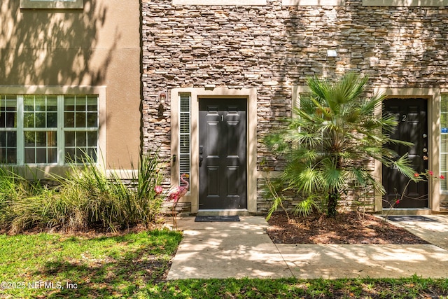 7250 Deerfoot Point Cir Unit 1, Jacksonville, FL 32256 - property entrance featuring stucco siding and stone siding