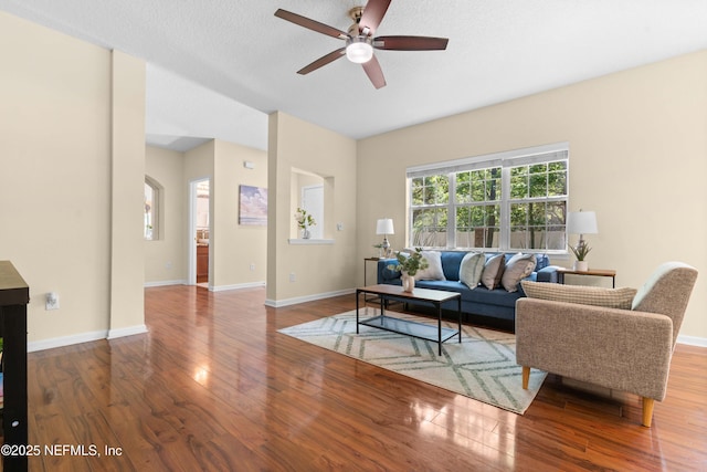7250 Deerfoot Point Cir Unit 1, Jacksonville, FL 32256 - living room featuring baseboards, a ceiling fan, and wood finished floors
