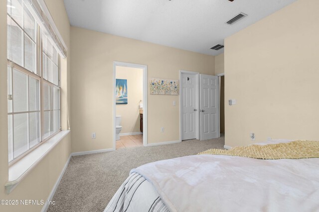 7250 Deerfoot Point Cir Unit 1, Jacksonville, FL 32256 - bedroom featuring carpet flooring, visible vents, baseboards, and connected bathroom