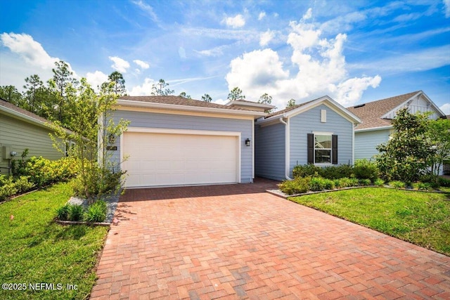 ranch-style home with a garage, decorative driveway, and a front lawn