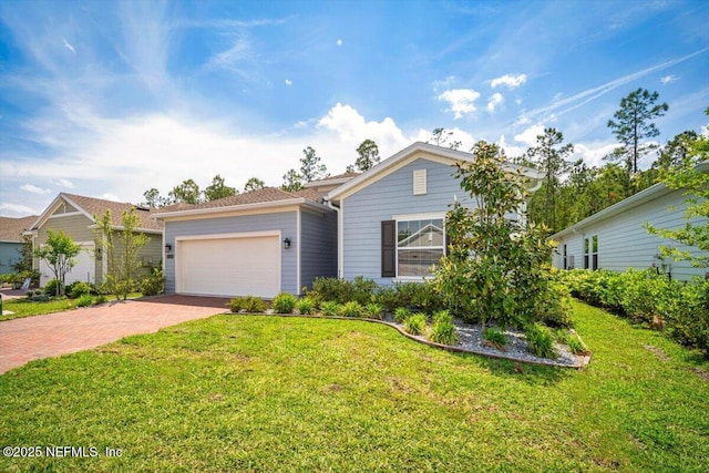 view of front facade with decorative driveway, a front lawn, and a garage