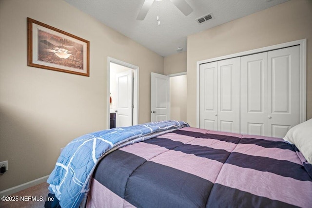 carpeted bedroom with a textured ceiling, a ceiling fan, baseboards, visible vents, and a closet