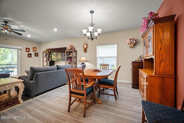 dining area with baseboards, wood tiled floor, recessed lighting, a textured ceiling, and ceiling fan with notable chandelier