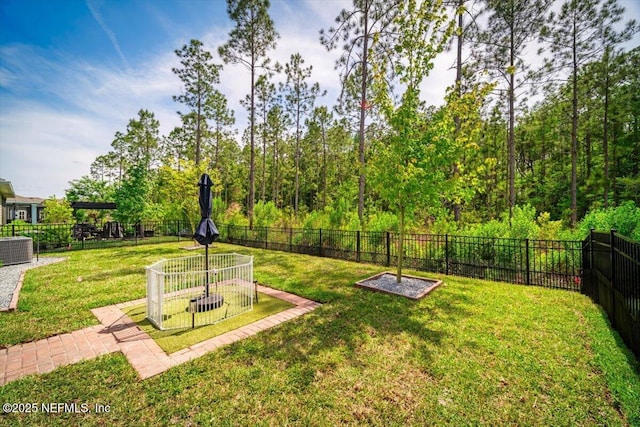 view of yard with a fenced backyard and central air condition unit