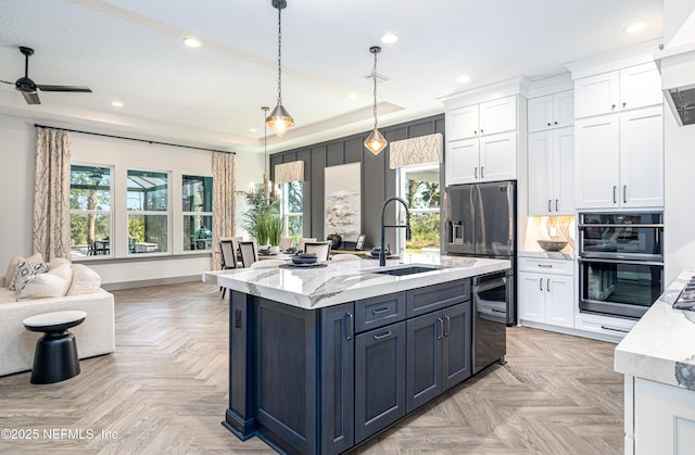 367 Maralinda Dr, Saint Augustine, FL 32095 - kitchen with a tray ceiling, white cabinets, recessed lighting, a sink, and hanging light fixtures