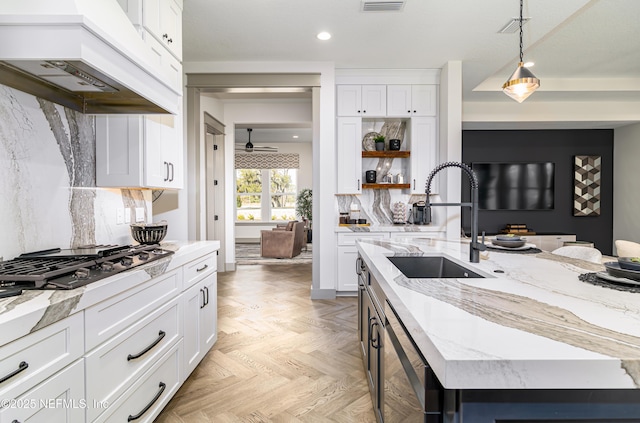 367 Maralinda Dr, Saint Augustine, FL 32095 - kitchen with white cabinetry, premium range hood, open shelves, gas cooktop, and a sink