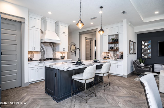 367 Maralinda Dr, Saint Augustine, FL 32095 - kitchen featuring premium range hood, stainless steel gas stovetop, open shelves, and visible vents