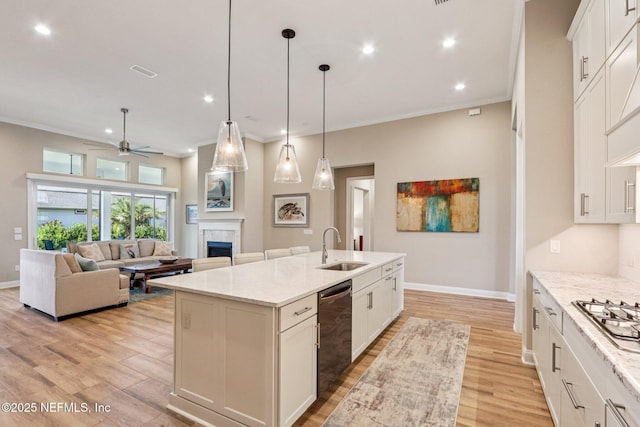 95566 Amelia National Pkwy, Fernandina Beach, FL 32034 - kitchen featuring dishwasher, a fireplace, light wood-style flooring, a ceiling fan, and stainless steel gas stovetop