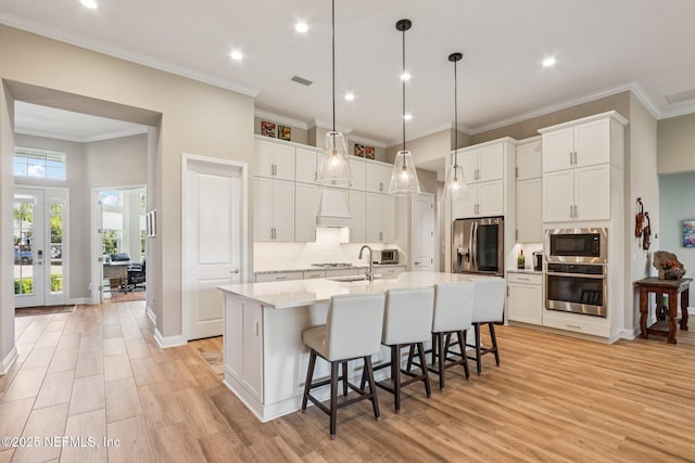 95566 Amelia National Pkwy, Fernandina Beach, FL 32034 - kitchen with appliances with stainless steel finishes, light wood-style floors, light countertops, white cabinetry, and recessed lighting
