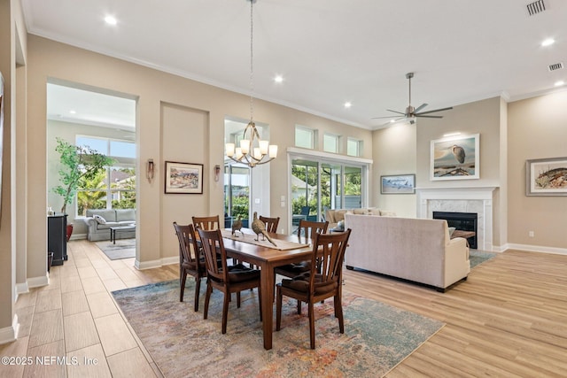 95566 Amelia National Pkwy, Fernandina Beach, FL 32034 - dining space with a high end fireplace, plenty of natural light, recessed lighting, ceiling fan, and crown molding