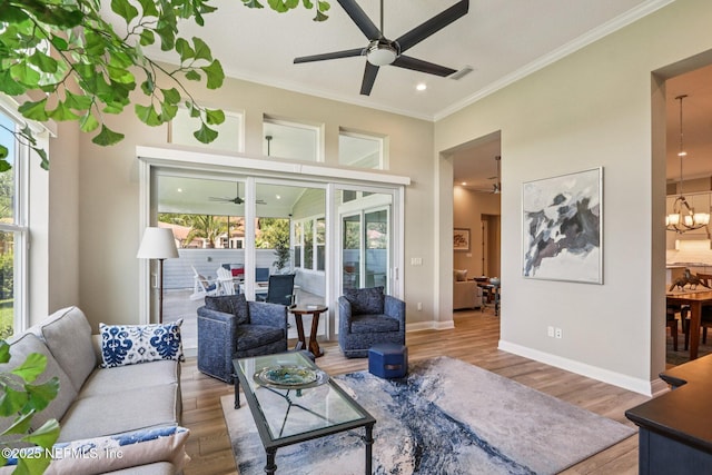 95566 Amelia National Pkwy, Fernandina Beach, FL 32034 - living area featuring ceiling fan, ornamental molding, plenty of natural light, wood finished floors, and a chandelier