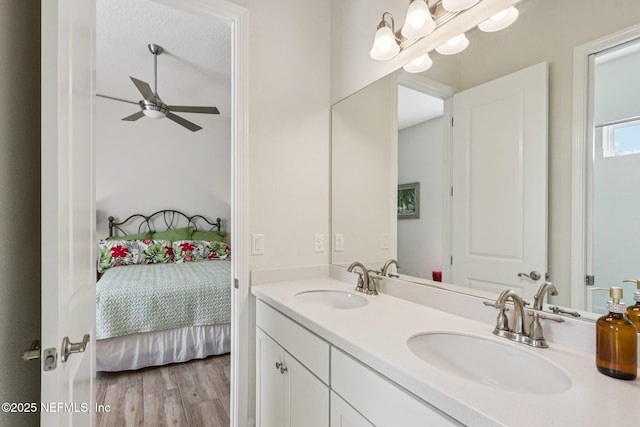 95566 Amelia National Pkwy, Fernandina Beach, FL 32034 - ensuite bathroom featuring double vanity, ceiling fan, and wood finished floors