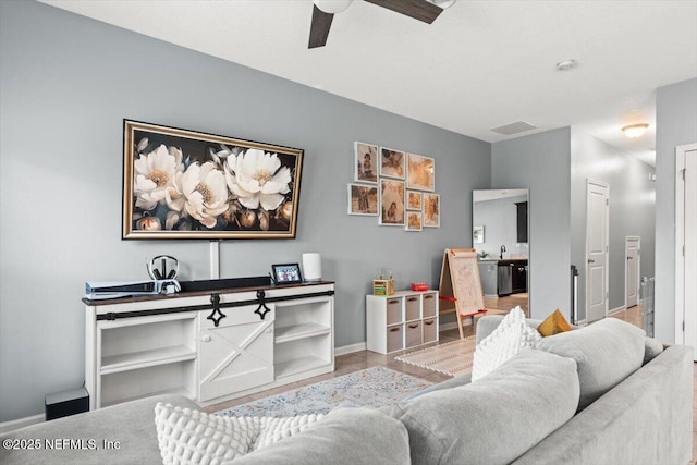 1580 Landau Rd, Jacksonville, FL 32225 - living room featuring a ceiling fan, baseboards, and wood finished floors
