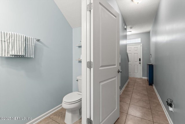 1580 Landau Rd, Jacksonville, FL 32225 - bathroom featuring tile patterned flooring, baseboards, toilet, and a textured ceiling