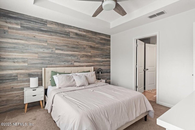 1580 Landau Rd, Jacksonville, FL 32225 - carpeted bedroom with an accent wall, wood walls, ceiling fan, baseboards, and a raised ceiling