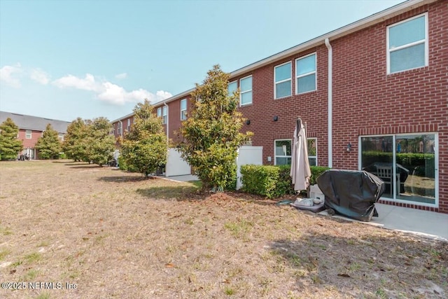 1580 Landau Rd, Jacksonville, FL 32225 - rear view of house featuring brick siding and a yard