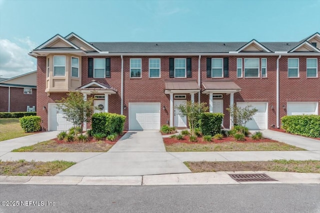 1580 Landau Rd, Jacksonville, FL 32225 - townhome / multi-family property with a garage, brick siding, and driveway