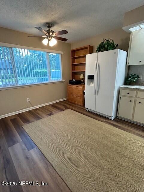 9360 Craven Rd # 607, Jacksonville, FL 32257 - kitchen featuring white refrigerator with ice dispenser, a ceiling fan, a textured ceiling, white cabinets, and wood finished floors