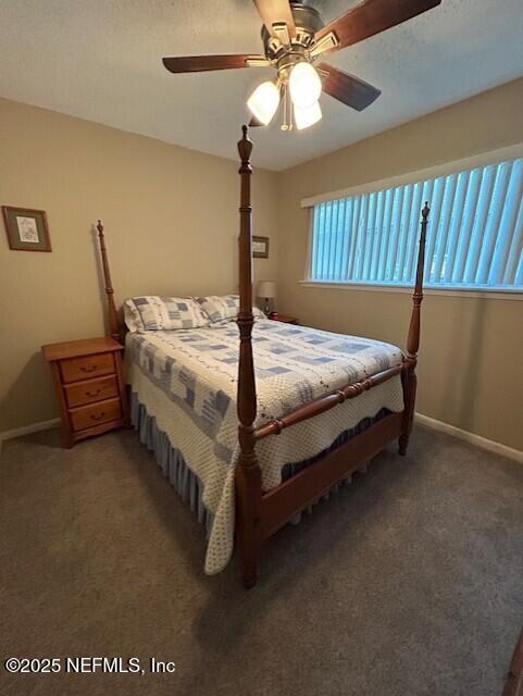 9360 Craven Rd # 607, Jacksonville, FL 32257 - bedroom featuring a ceiling fan, baseboards, and light carpet
