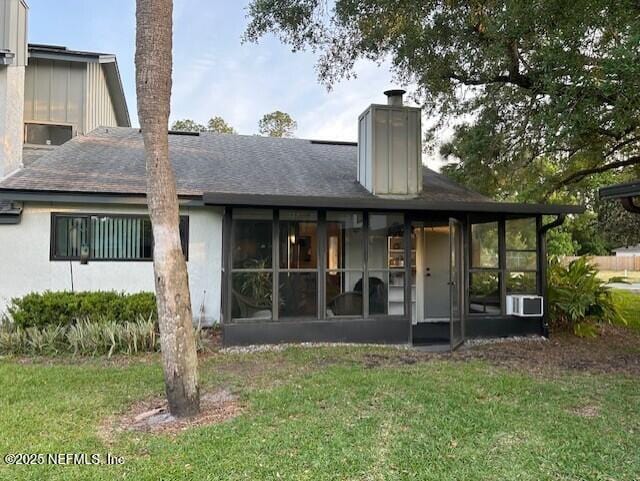 9360 Craven Rd # 607, Jacksonville, FL 32257 - back of property featuring a chimney, a yard, and a sunroom
