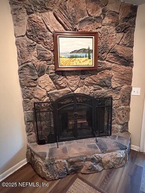 9360 Craven Rd # 607, Jacksonville, FL 32257 - details featuring wood finished floors, a stone fireplace, and baseboards