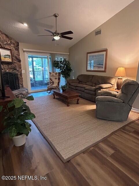 9360 Craven Rd # 607, Jacksonville, FL 32257 - living room with wood finished floors, a fireplace, visible vents, a ceiling fan, and lofted ceiling