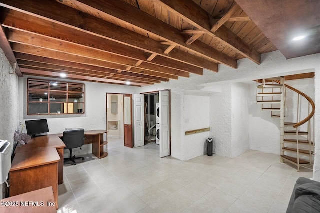 below grade area featuring wooden ceiling, a textured wall, and stairs