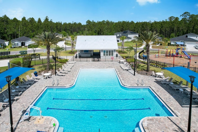 597 Meadow Ridge Dr, Saint Augustine, FL 32092 - community pool with fence, a view of trees, and a patio area