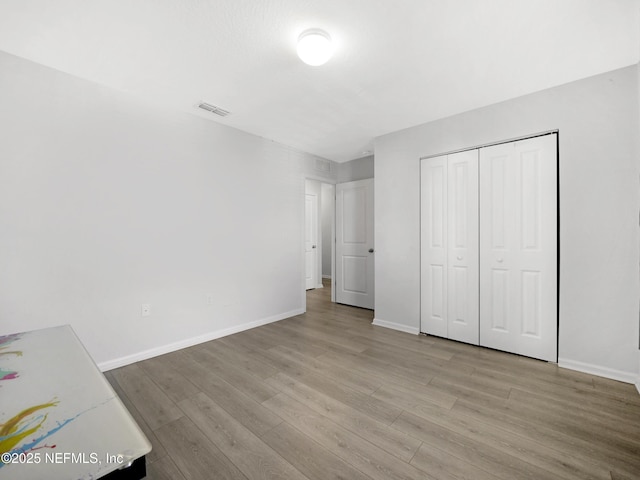597 Meadow Ridge Dr, Saint Augustine, FL 32092 - unfurnished bedroom featuring baseboards, visible vents, and light wood finished floors