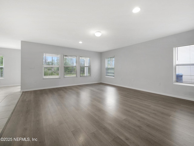 597 Meadow Ridge Dr, Saint Augustine, FL 32092 - unfurnished living room featuring recessed lighting, baseboards, and dark wood-style floors