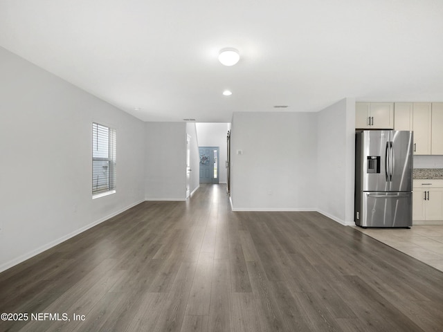 597 Meadow Ridge Dr, Saint Augustine, FL 32092 - unfurnished living room with baseboards and wood finished floors