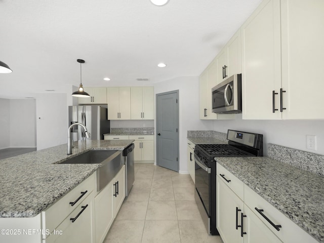 597 Meadow Ridge Dr, Saint Augustine, FL 32092 - kitchen featuring light stone countertops, baseboards, a sink, hanging light fixtures, and stainless steel appliances