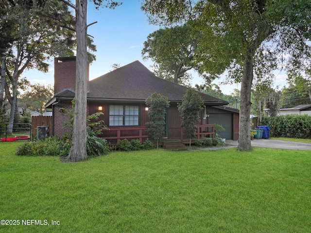 ranch-style house with an attached garage, a front lawn, and driveway