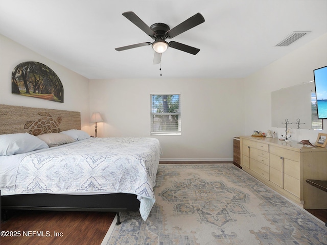 bedroom with baseboards, visible vents, and ceiling fan