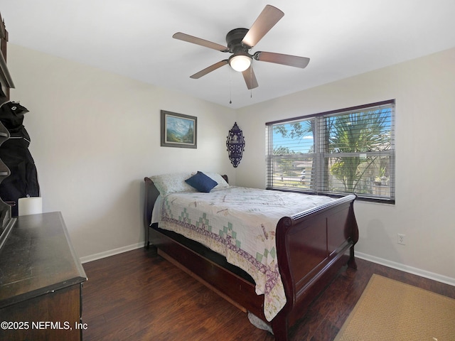 bedroom featuring wood finished floors, baseboards, and ceiling fan