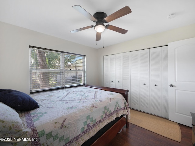 bedroom with a ceiling fan, wood finished floors, and a closet