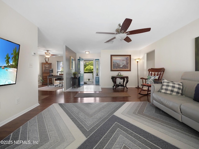 living area with wood finished floors, baseboards, and ceiling fan