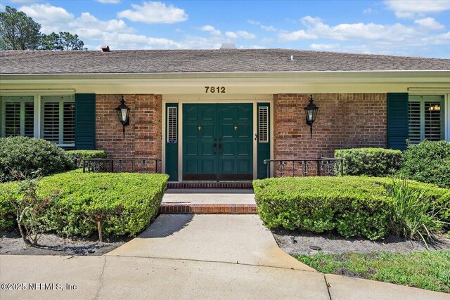 7812 Hunters Grove Rd, Jacksonville, FL 32256 - property entrance featuring brick siding and covered porch