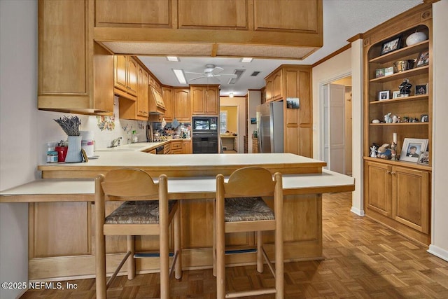 7812 Hunters Grove Rd, Jacksonville, FL 32256 - kitchen featuring light countertops, premium range hood, a peninsula, black microwave, and stainless steel refrigerator