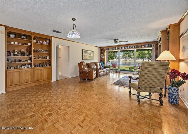 7812 Hunters Grove Rd, Jacksonville, FL 32256 - living room with visible vents, baseboards, ornamental molding, a ceiling fan, and a textured ceiling