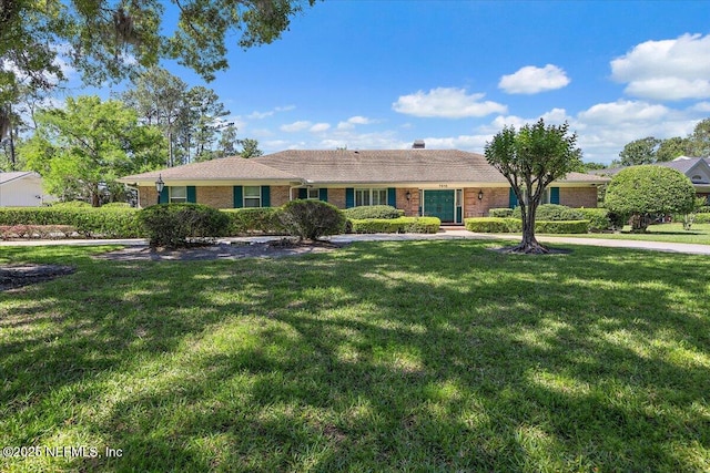 7812 Hunters Grove Rd, Jacksonville, FL 32256 - ranch-style home with brick siding and a front lawn