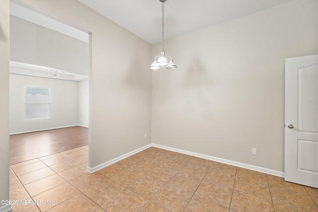 80 St Croix Island Dr, Saint Augustine, FL 32092 - unfurnished dining area with light tile patterned floors, a chandelier, and vaulted ceiling