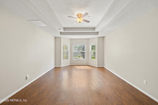 80 St Croix Island Dr, Saint Augustine, FL 32092 - spare room with a ceiling fan, a tray ceiling, a textured ceiling, and wood finished floors