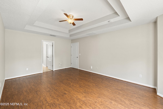 80 St Croix Island Dr, Saint Augustine, FL 32092 - unfurnished room featuring a tray ceiling, ceiling fan, dark wood-style floors, and a smoke detector