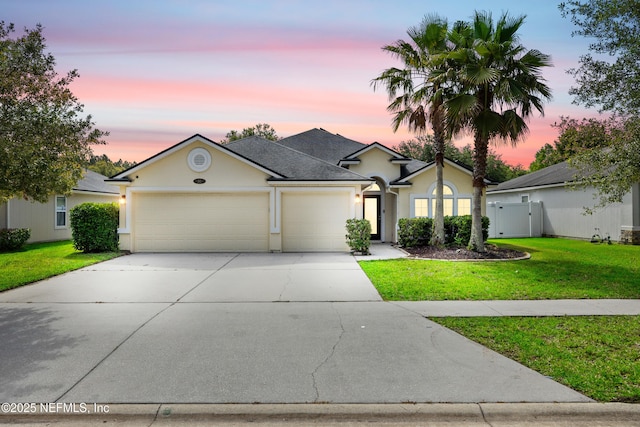 80 St Croix Island Dr, Saint Augustine, FL 32092 - view of front of house featuring an attached garage, driveway, stucco siding, roof with shingles, and a gate