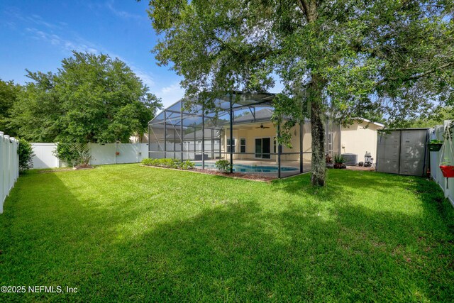 80 St Croix Island Dr, Saint Augustine, FL 32092 - fenced backyard featuring a ceiling fan, a lanai, and a patio area