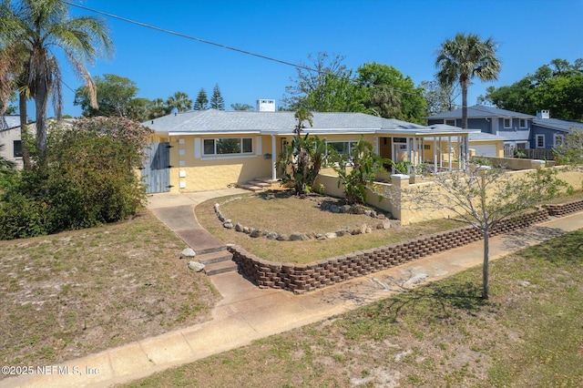 1800 N Halifax Ave, Daytona Beach, FL 32118 - ranch-style home with a front lawn and stucco siding