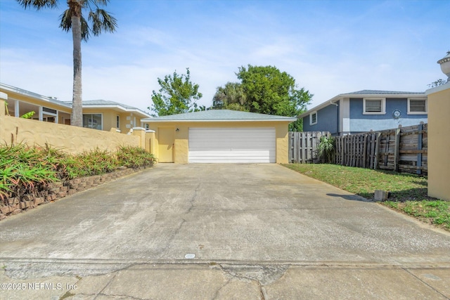 1800 N Halifax Ave, Daytona Beach, FL 32118 - view of front of home featuring stucco siding, fence, and a detached garage