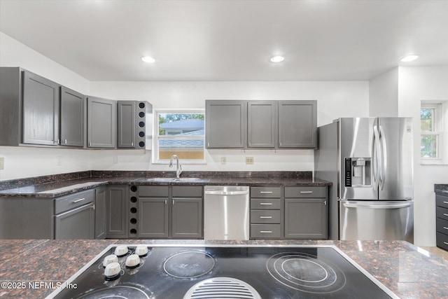 1800 N Halifax Ave, Daytona Beach, FL 32118 - kitchen with dark stone countertops, appliances with stainless steel finishes, gray cabinets, and a sink