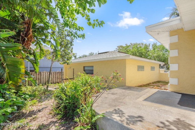 1800 N Halifax Ave, Daytona Beach, FL 32118 - exterior space with stucco siding, a patio, and fence